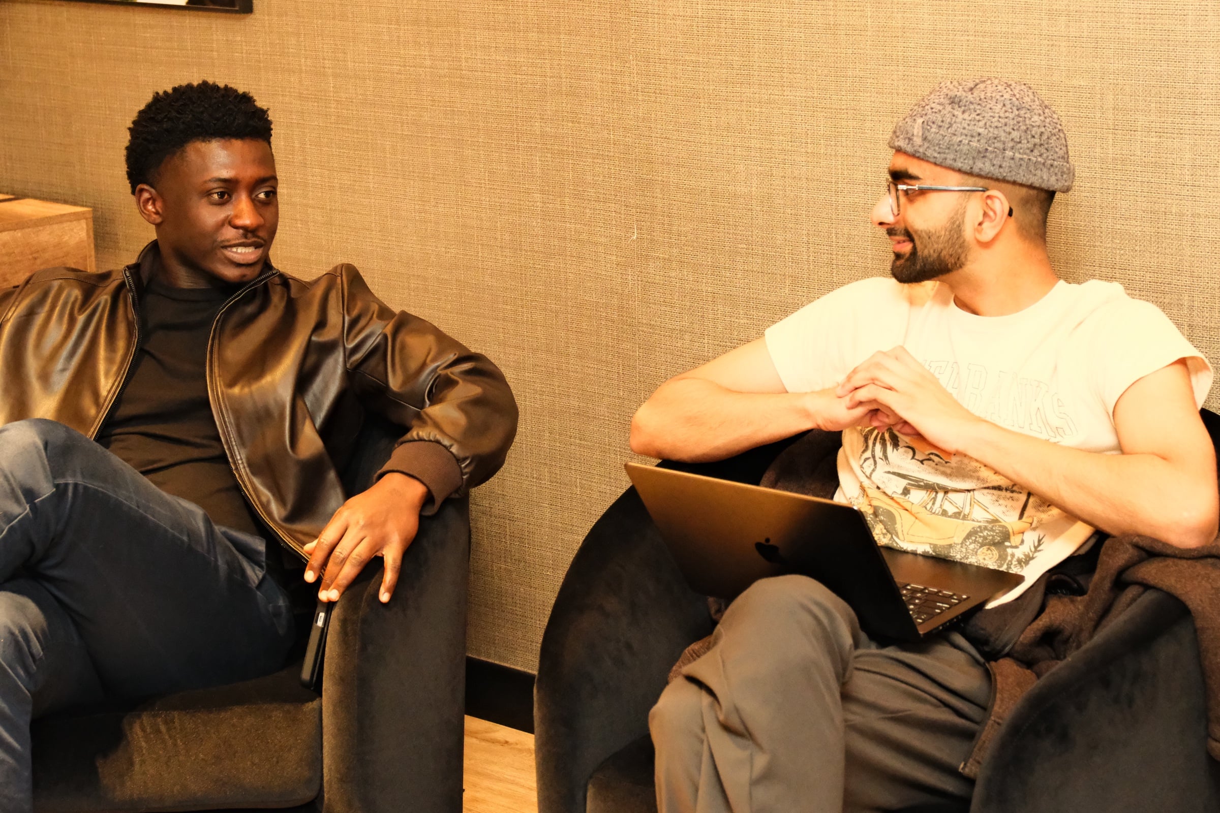 Two attendees in conversation in the penthouse lounge