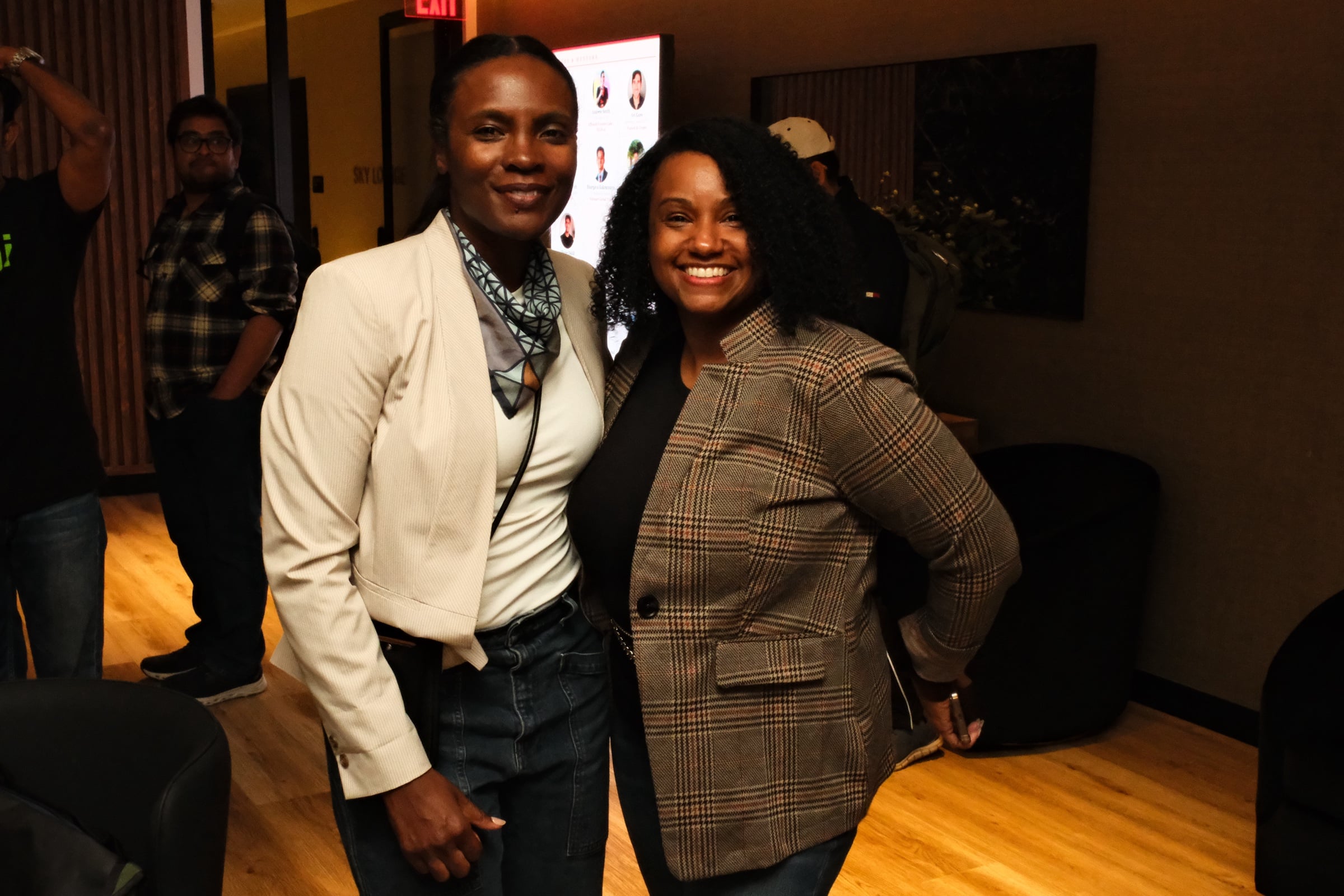 Two attendees posing together at the event
