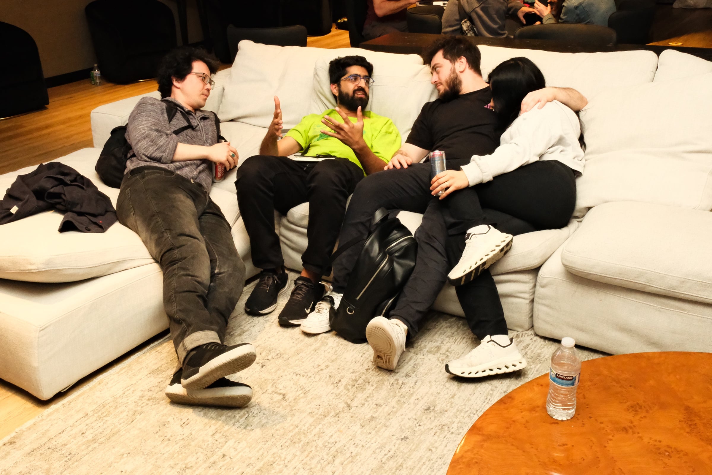 Attendees deep in conversation on the penthouse couch late into the evening