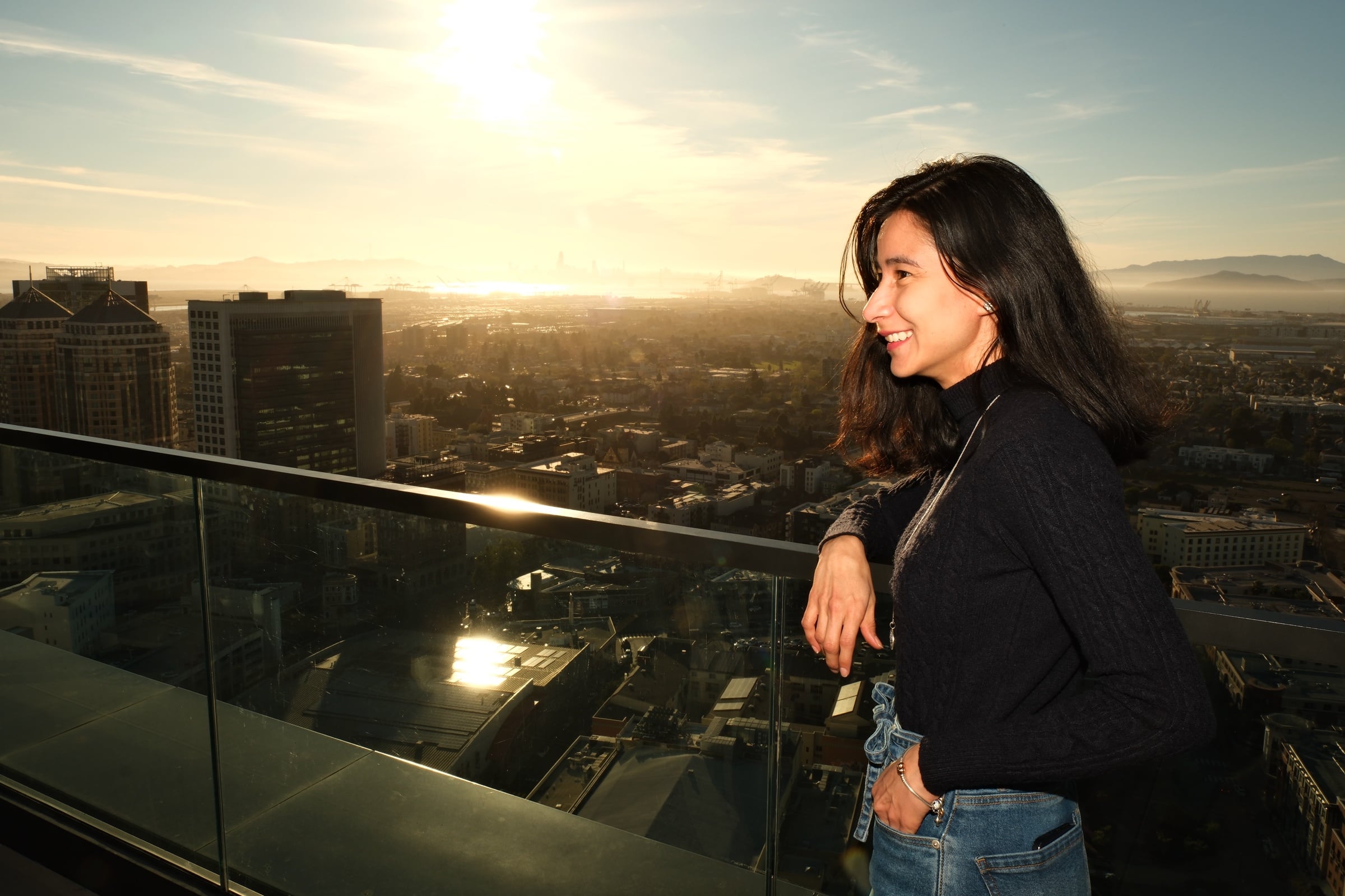 Attendee looking out over the Oakland skyline at sunset